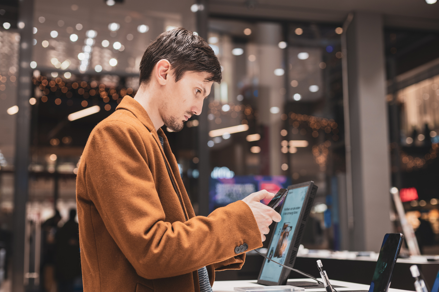 retail security professional calmly observing shop floor in large department store, customer friendly environment, discreet loss prevention, no aggressive imagery