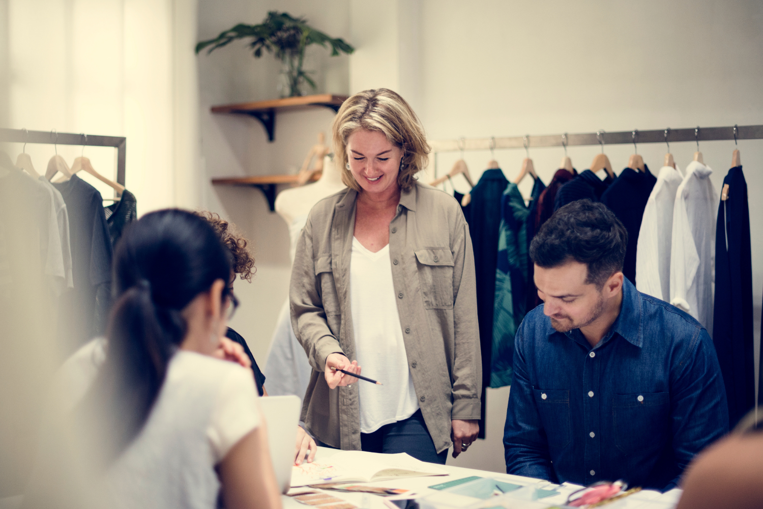 retail store manager checking sales floor in homeware or interiors store, clean product displays, warm natural light, professional store leadership